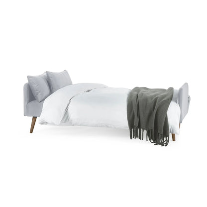 Gray bed with white bedding and a gray blanket on a white background