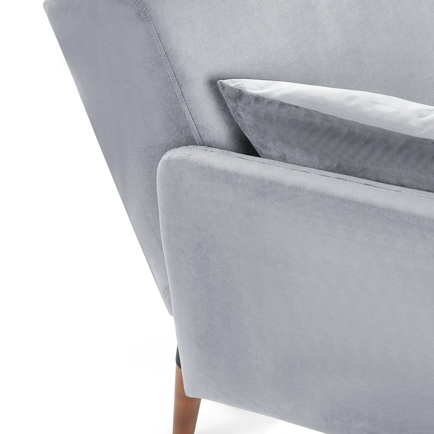 Gray velvet sofa with a cushion on a white background