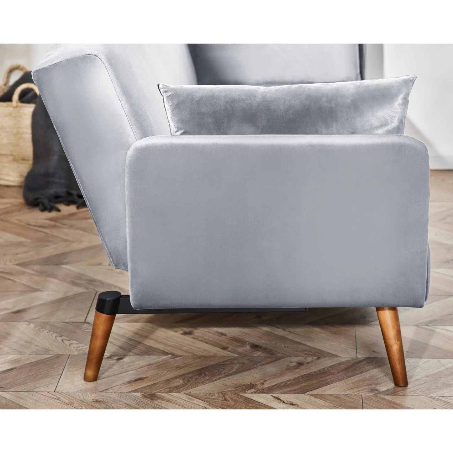 Gray sofa with wooden legs on a wooden floor