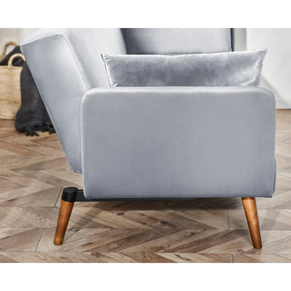 Gray sofa with wooden legs on a wooden floor