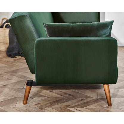 Green sofa bed with wooden legs on a wooden floor