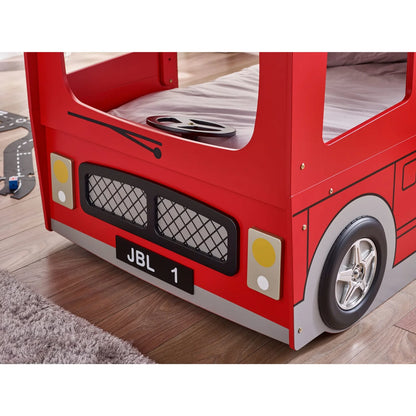 Red fire truck-themed bed with visible JBL branding on a wooden floor.