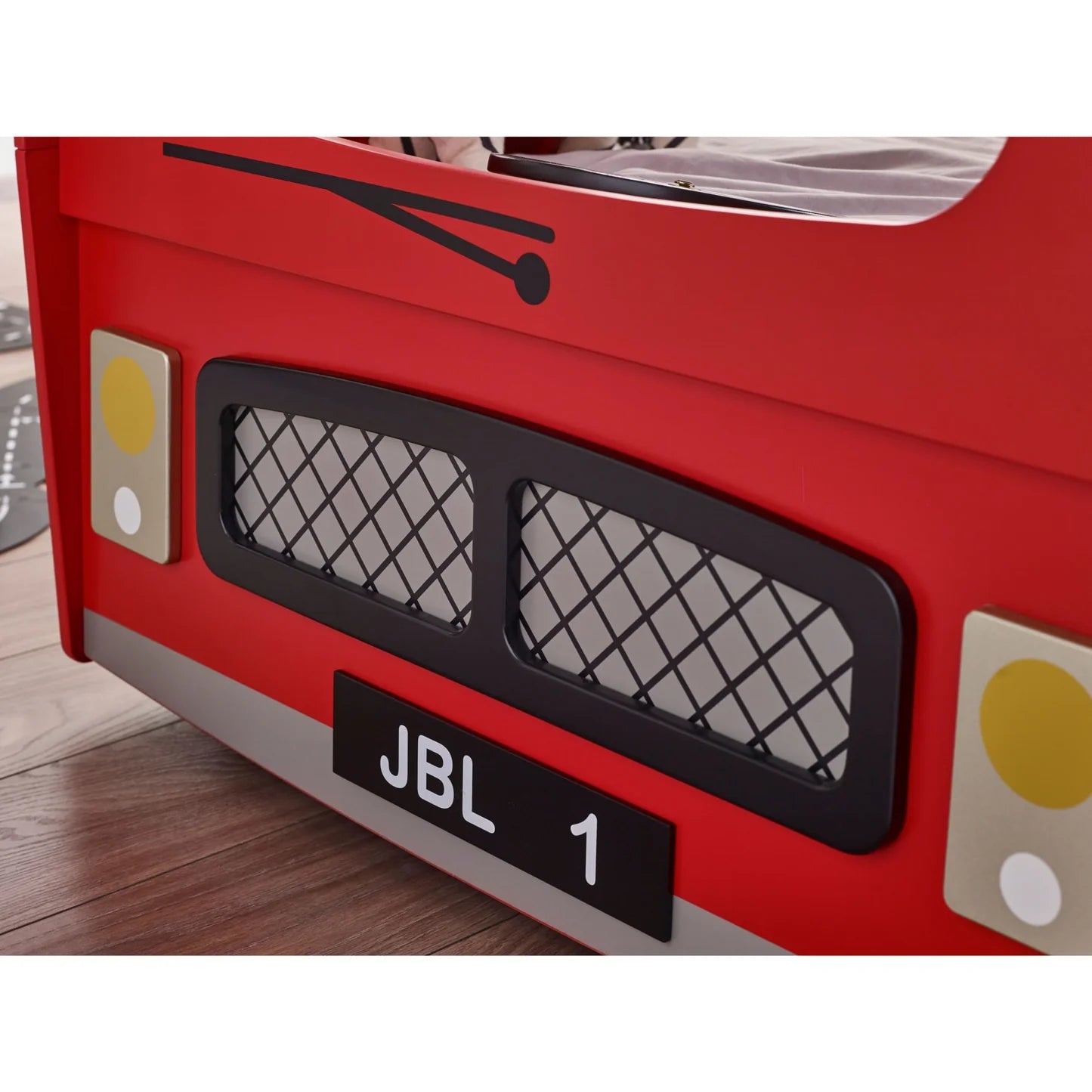 Red toy car with JBL branding on a wooden floor