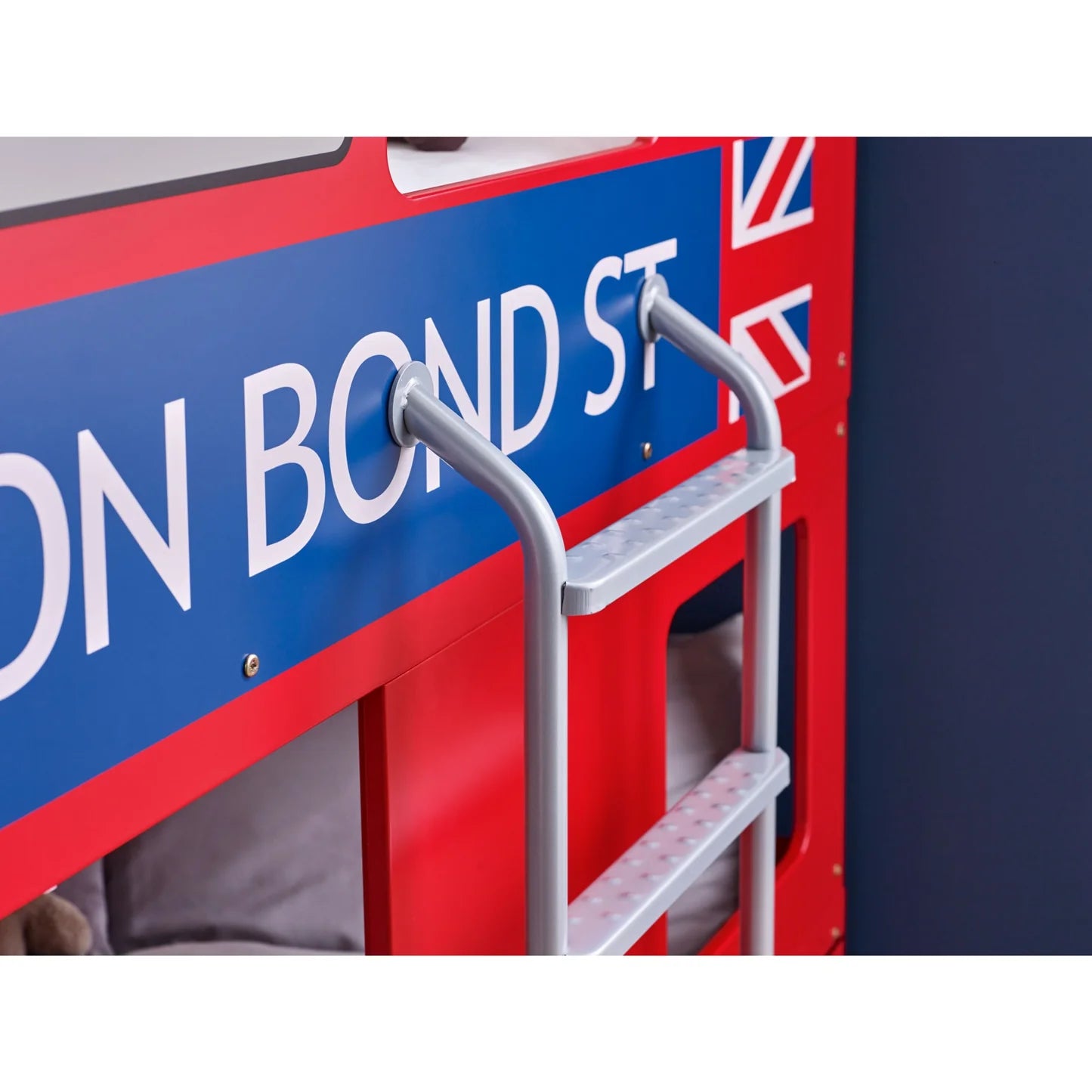 Close-up of a red double-decker bus with 'Bond St' sign and British flag.