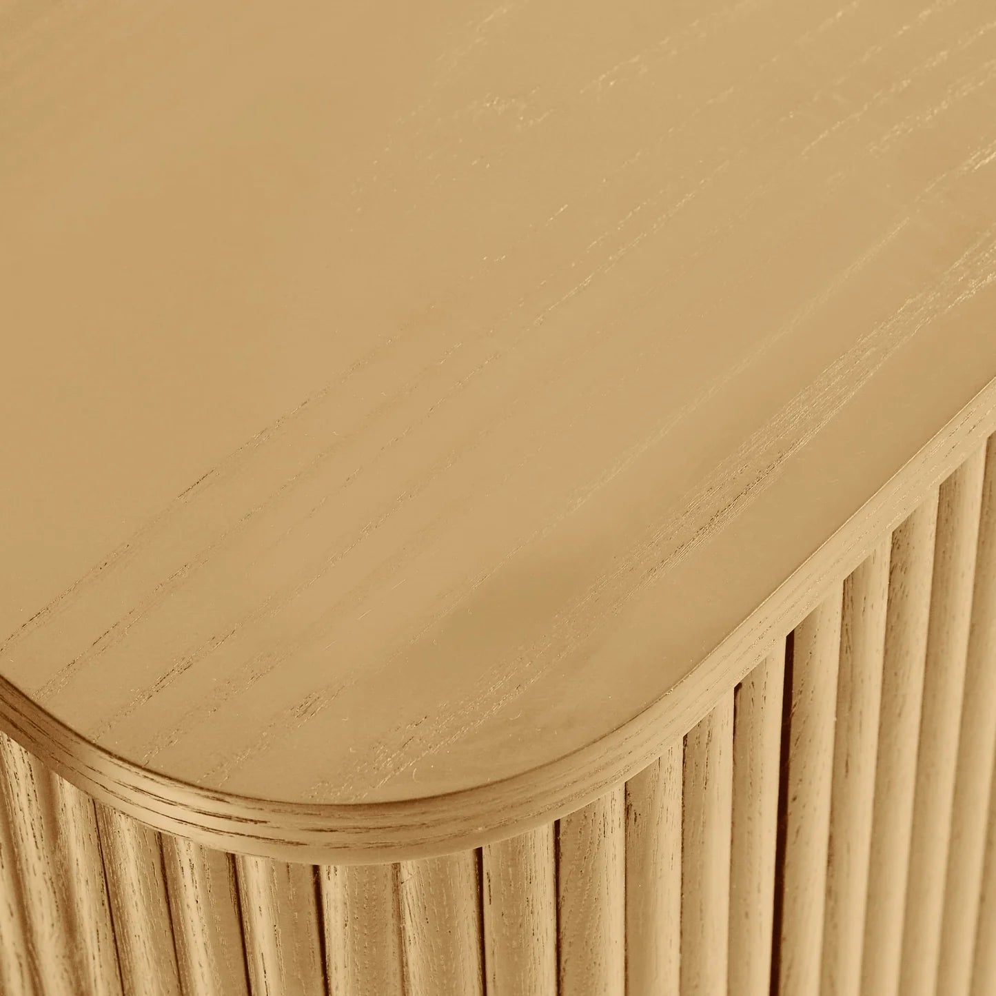 Close-up of a wooden surface with a curved edge and vertical slats.