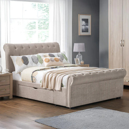Beige upholstered bed in a bedroom with a lamp, nightstand, and decor.