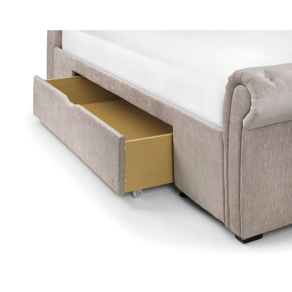 Beige upholstered bed with open drawer on a white background