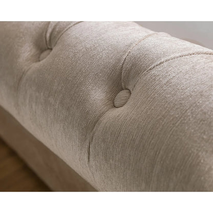 Close-up of a textured beige fabric surface with button details