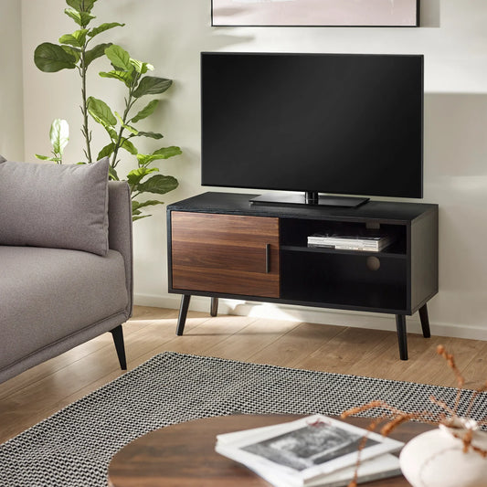 Modern living room with a TV on a wooden stand, gray sofa, and decorative items.