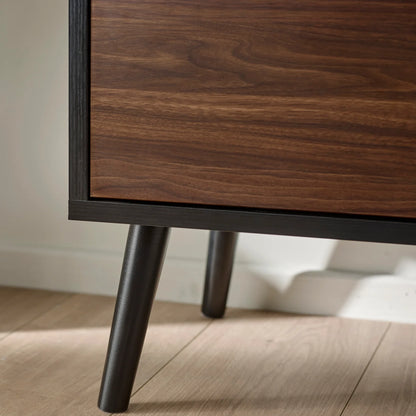 Wooden cabinet with dark legs on a light wooden floor