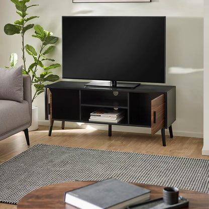Modern living room with a TV on a wooden stand, gray sofa, and decorative items.