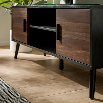 Wooden cabinet with black accents on a wooden floor